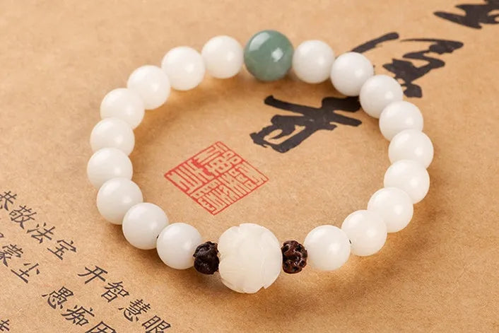 Natural white jade Bodhi bracelet with round beads and transfer bead on white background