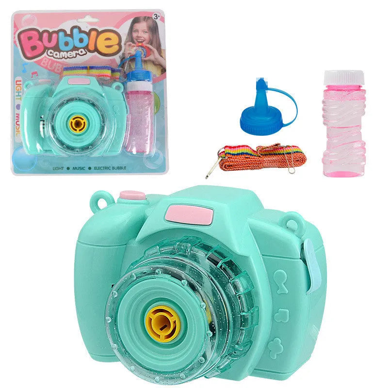 Yellow automatic camera-shaped bubble machine for children on a green lawn, producing soap bubbles.
