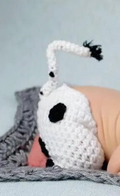 Hand-knitted white baby cow suit with matching pants and hat for newborns