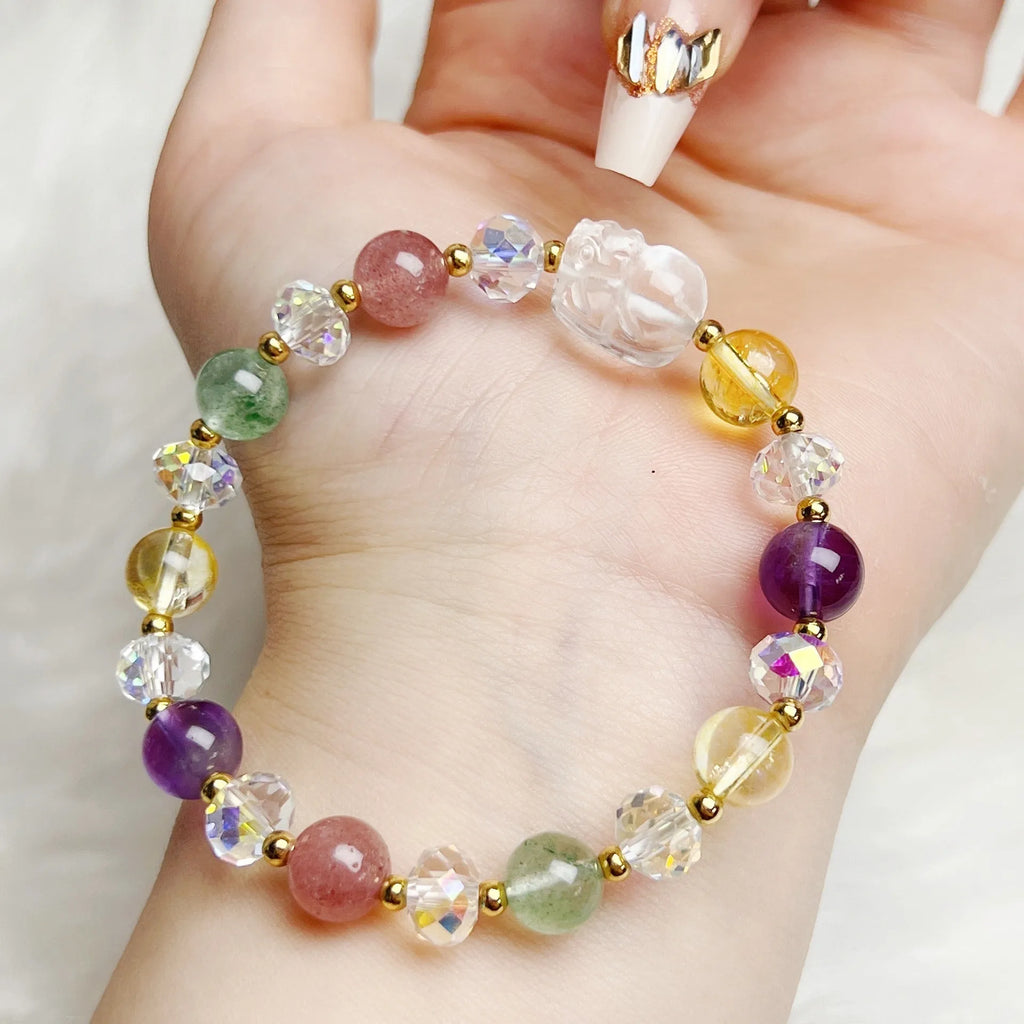 Close-up of a manually crafted crystal bracelet with a nine-tail fox centrepiece on a wrist.