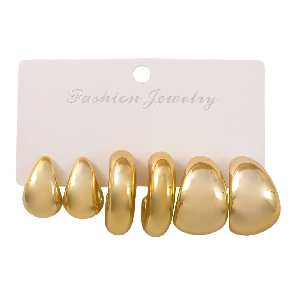 Set of three pairs of acrylic double circle earrings in gold, silver, and black with water drop design