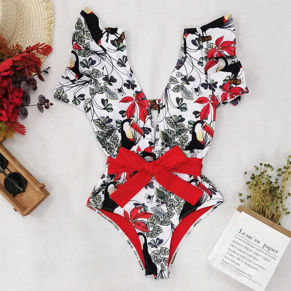 Blue printed one-piece swimsuit for women with one-shoulder ruffle and chest pad on white background