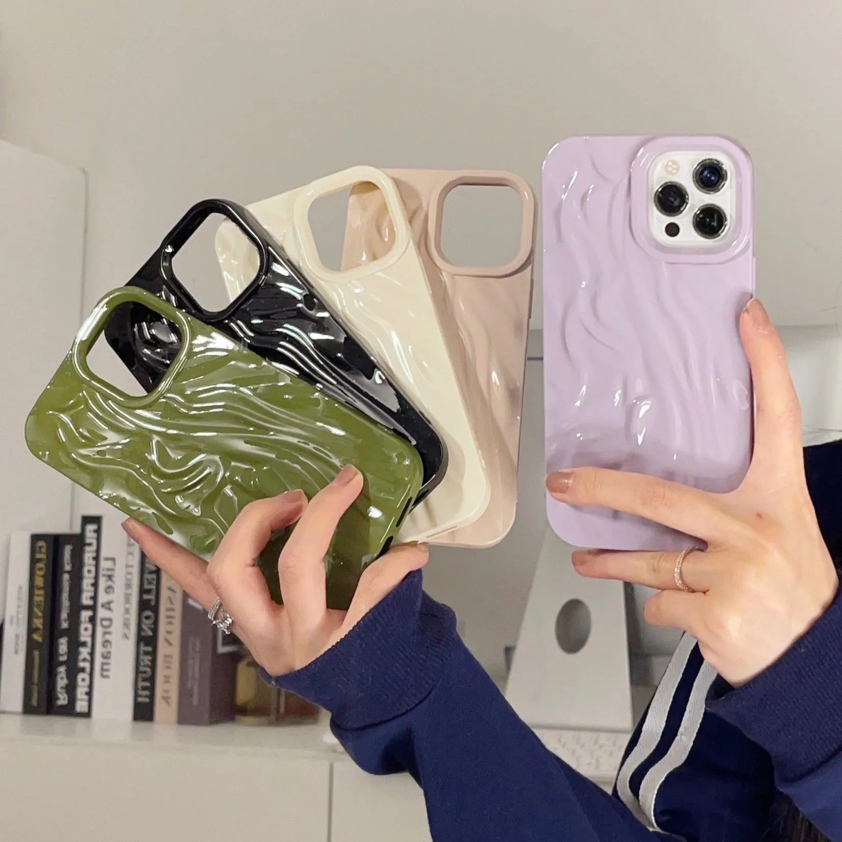 Milky white silicone iPhone case with a water ripple texture on a table.