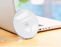 Glass disc wireless charger in black or white showing charging indication