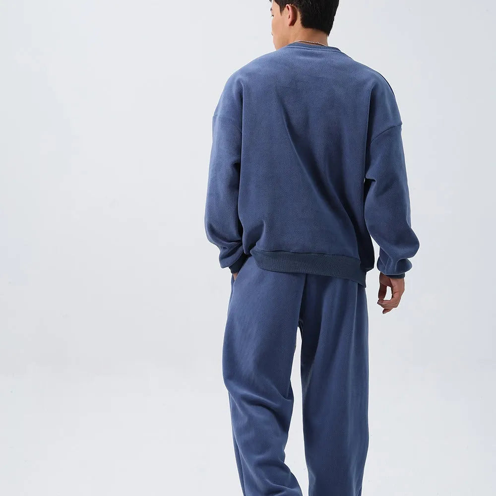 Men's black polar fleece winter sports suit with loose fit long sleeve coat and matching trousers