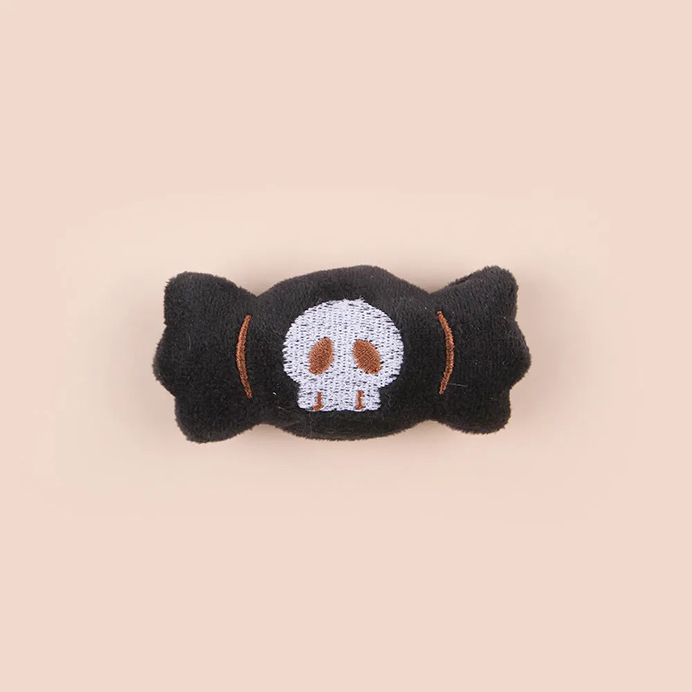 Small plush cat teaser wand with colourful eyes, candy and skull shaped attachments