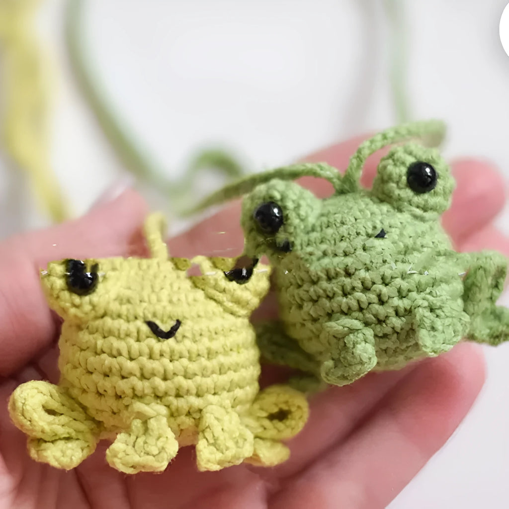 Handmade woven green plush frog pendant for car interior decoration.