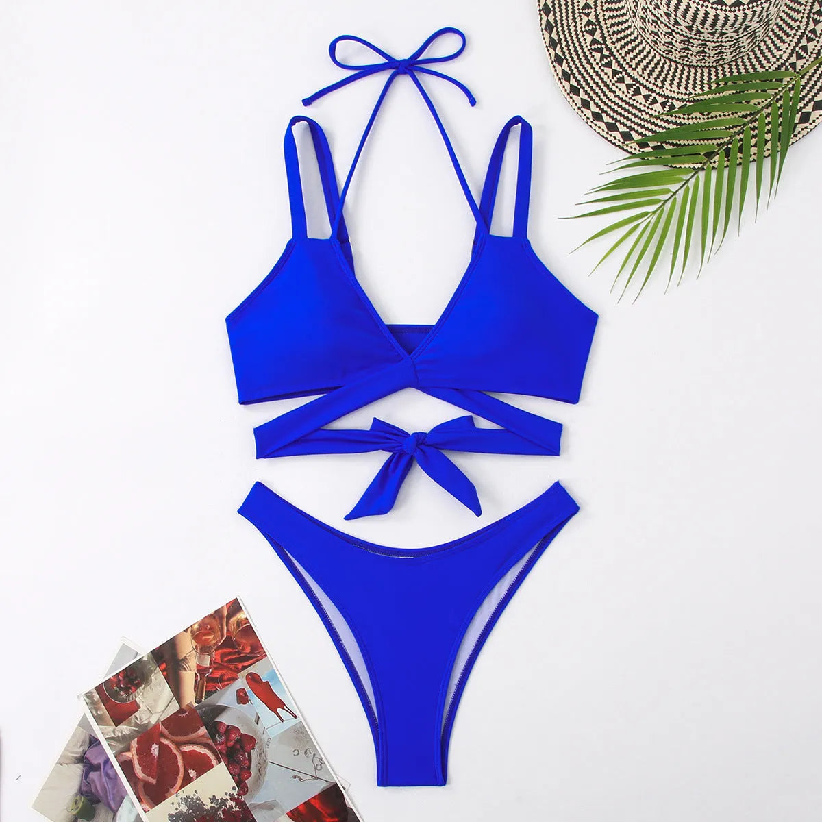 Women's solid colour strappy bikini swimsuit on a hanger, showing the briefs style and strap design.