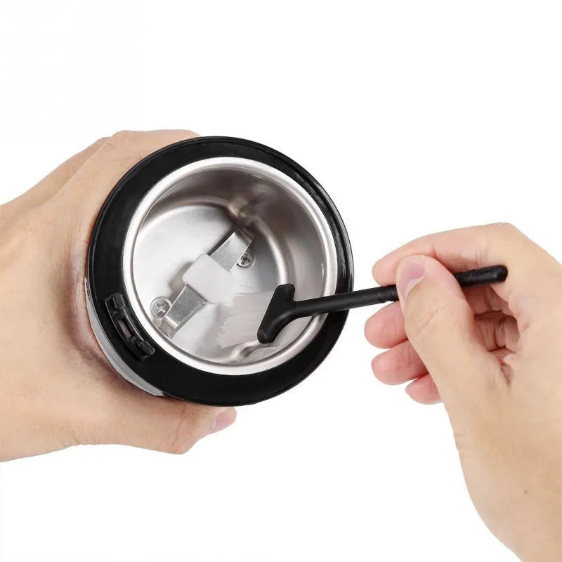 Black mini electric grinder with stainless steel liner for grinding coffee beans and nuts