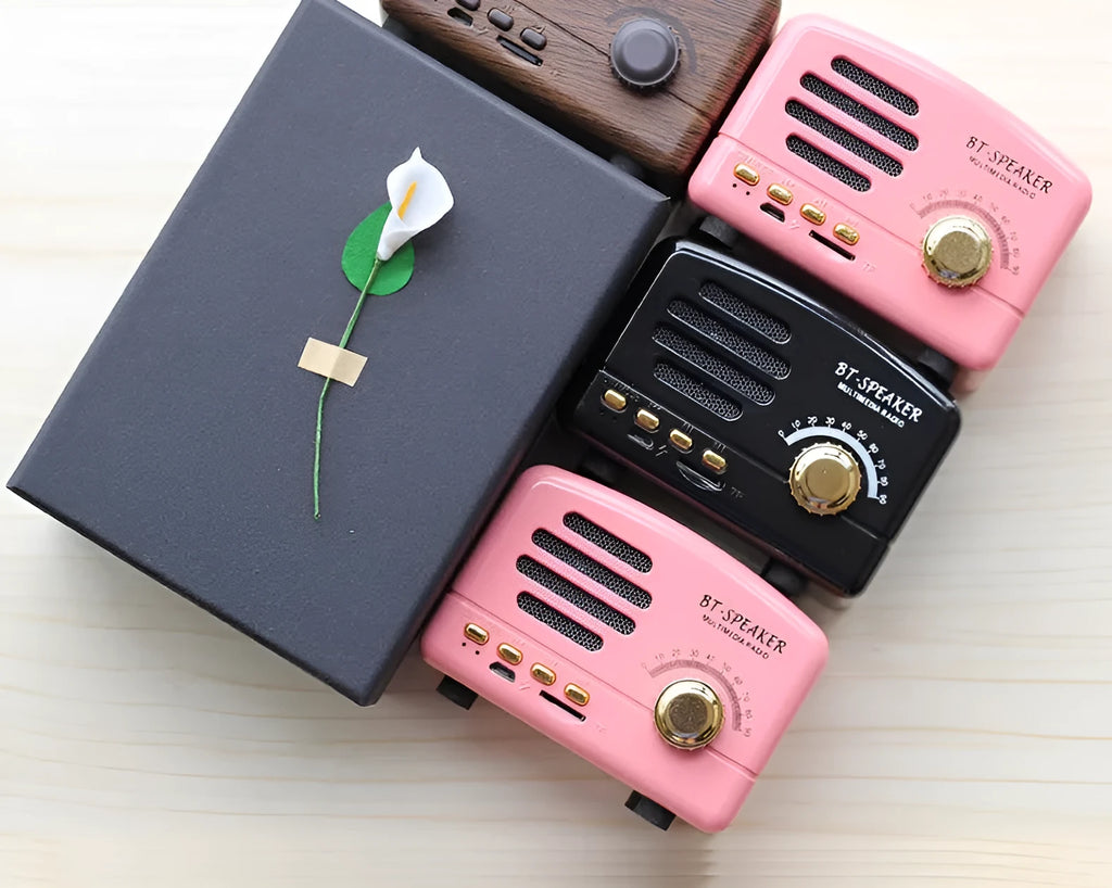 Compact vintage-style wood grain finish Bluetooth speaker on a wooden table.