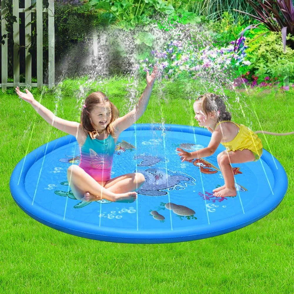 Blue children's water spray mat with marine animals laid on grass, connected to a garden hose.