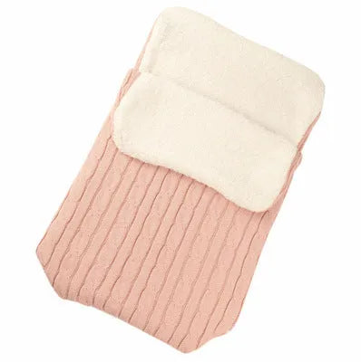 Envelope-style baby stroller sleeping bag in beige colour with thick filling, shown next to a pram.