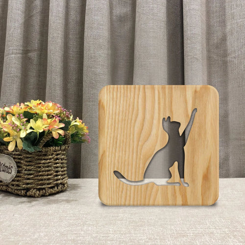 Solid wood 3D cat silhouette night light with hollow design and USB power cord.