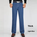 Men's high-waist loose fit blue denim trousers on a hanger, showing the casual cut and zipper fly.