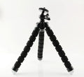 Black flexible octopus tripod with smartphone mount showing wrapped leg positioning