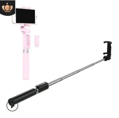 Black Bluetooth selfie stick with tripod base and remote control extended next to smartphone