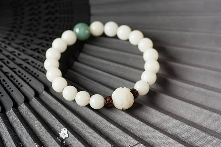 Natural white jade Bodhi bracelet with round beads and transfer bead on white background