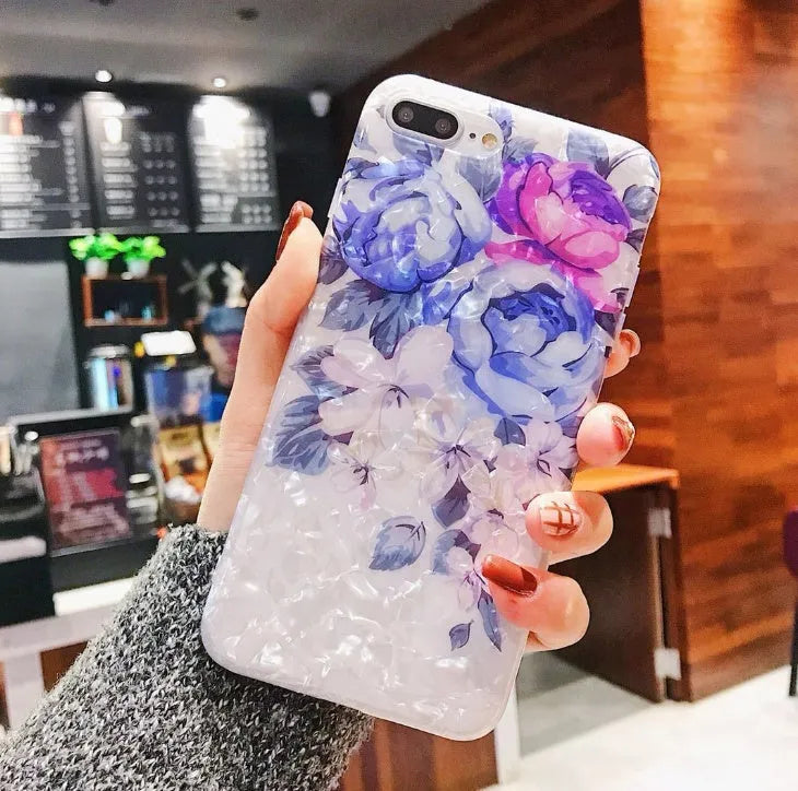 Dream Shell soft TPU iPhone case with rose flower design in brown, shown on an iPhone.