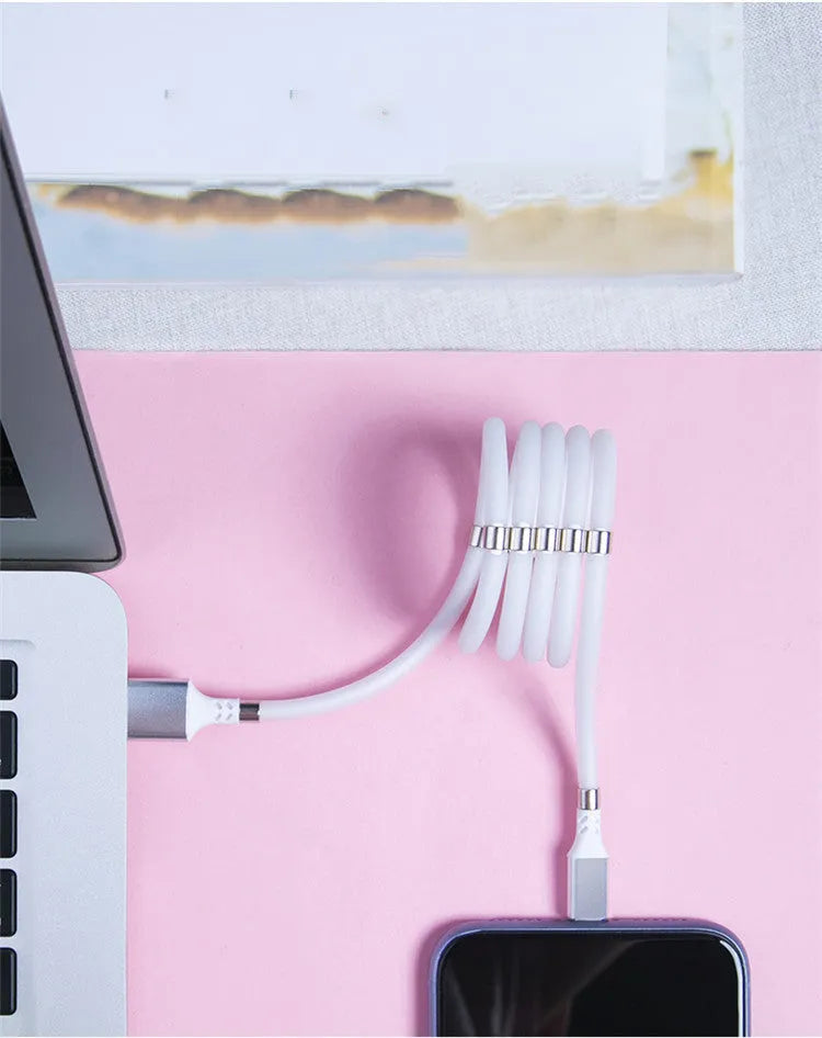 Black magnetic charging cable with multiple connector heads including USB-C, Micro USB and Apple-compatible 3.5mm