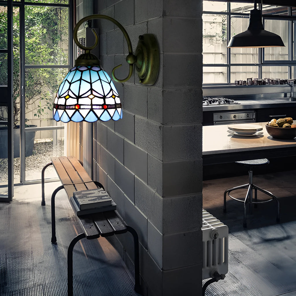A coloured stained glass wall lamp in a simple contemporary style, mounted on a wall.