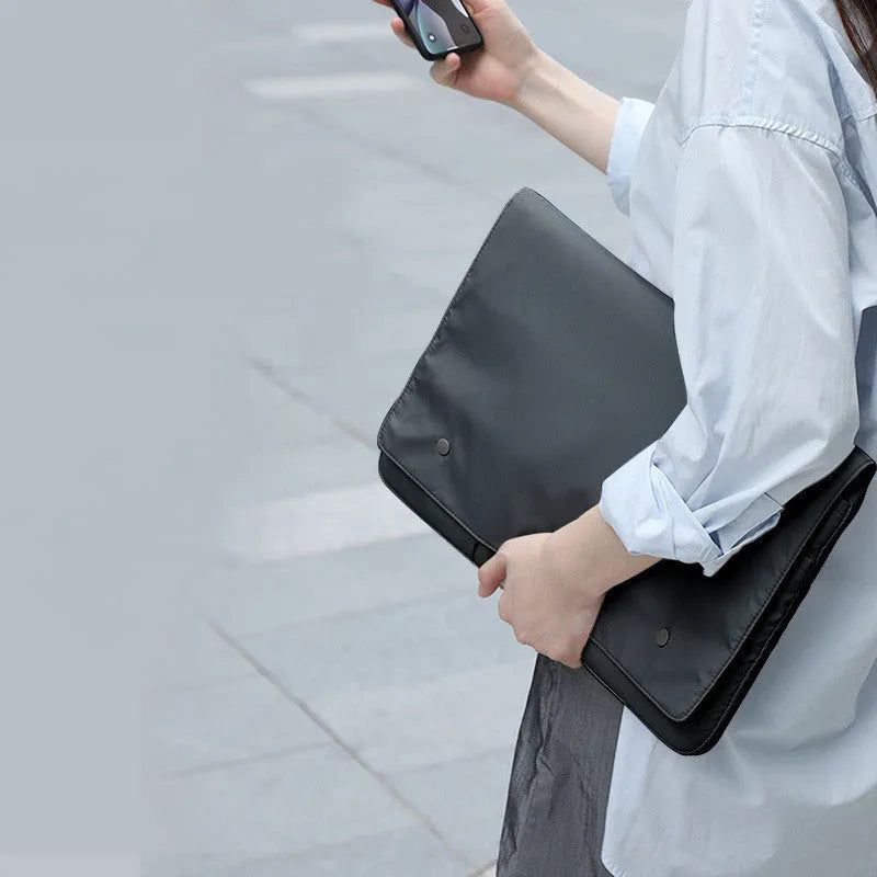 Black and white nylon laptop bag protective cover with flip opening and multiple pockets, available in 13-16 inch sizes.