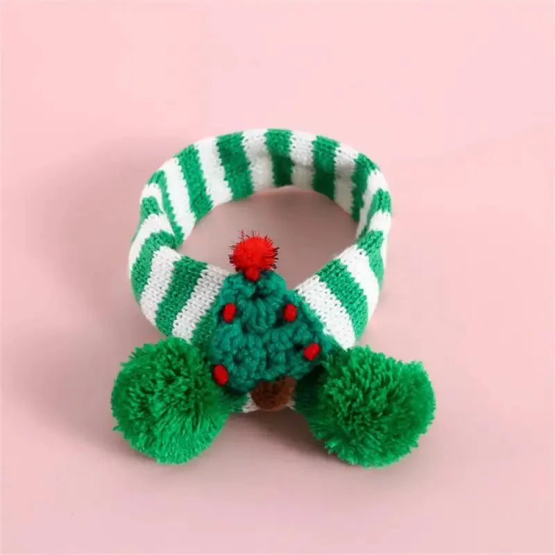 Green adjustable knitted scarf collar for a small dog on a white background