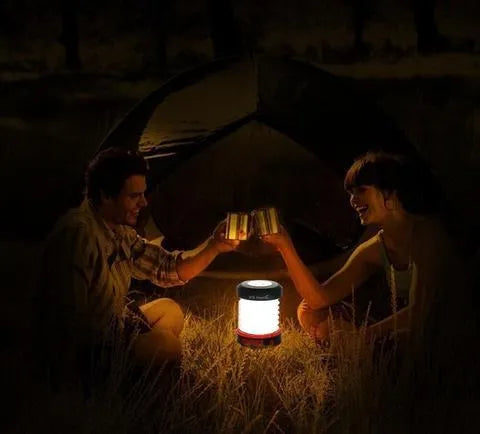 SolarBoom collapsible lantern in green with solar panel, collapsed for storage, on a wooden surface