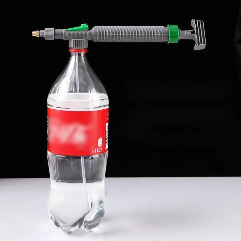 Grey watering sprayer nozzle attached to plastic bottle with 30cm connecting tube for garden watering