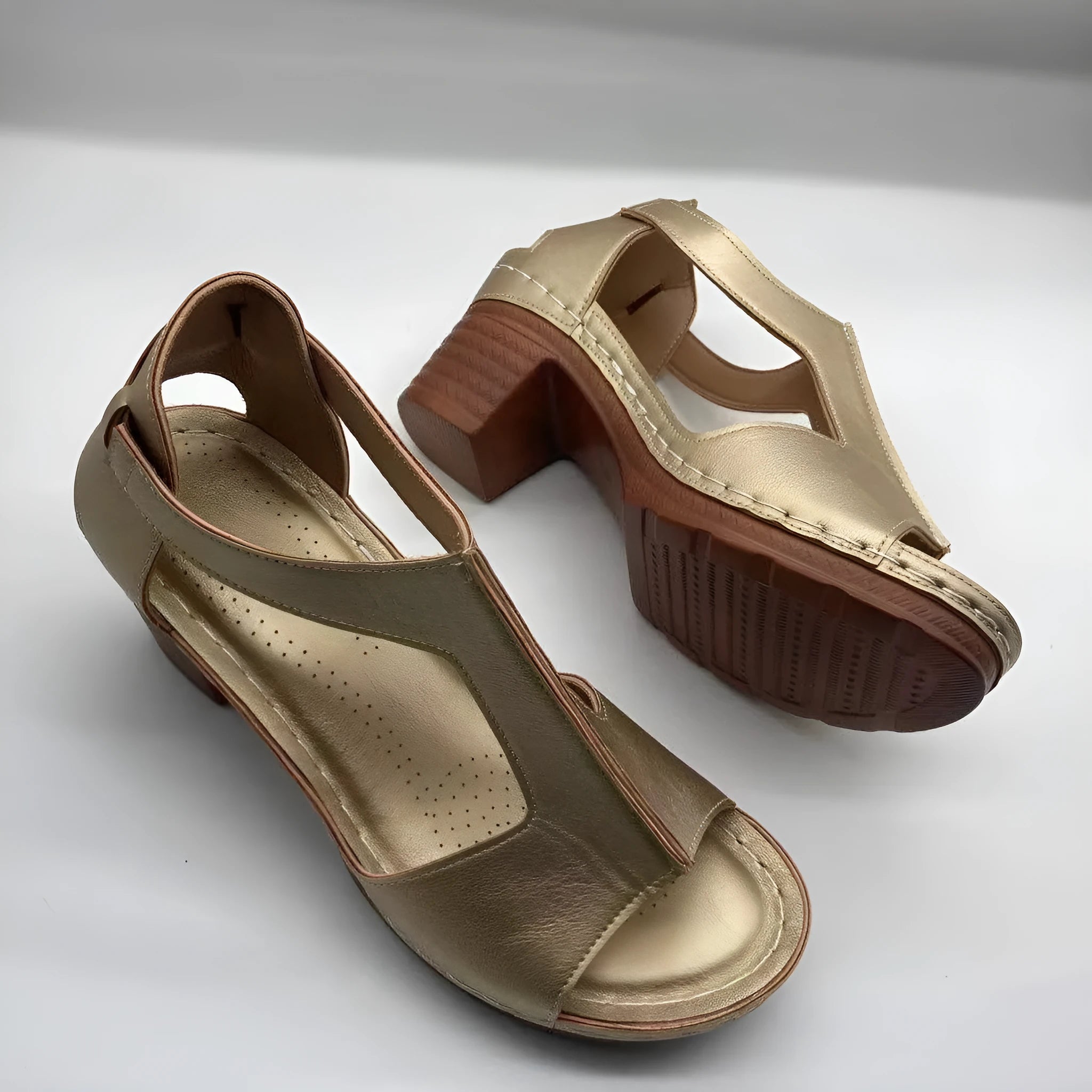 Women's beige peep toe wedge sandals with a buckle strap, shown on a foot.