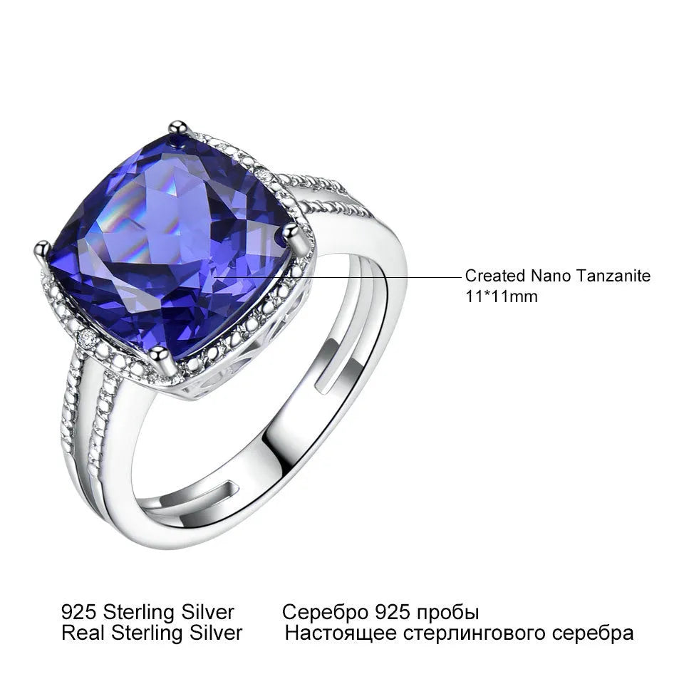 A women's sterling silver ring with a blue Tanzanite gemstone on a silver band.