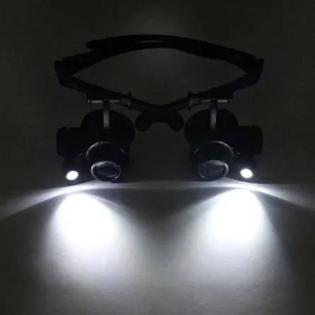Black double eye magnifier glasses with LED lights and interchangeable lenses for precision repair work