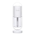 Pink Magic Shadow USB air humidifier with projection night lights on a wooden table.
