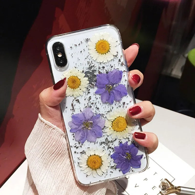Clear iPhone case with preserved dried flowers visible through transparent back, showing flower pink floral arrangement