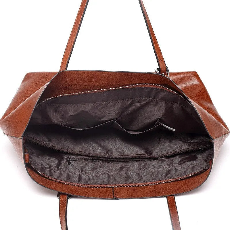 Brown waxed cowhide crossbody handbag showing two main compartments and an internal phone pocket.