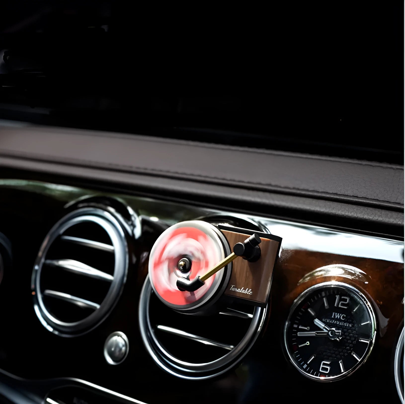 Black turntable car aroma diffuser with ocean scent fragrance tablet on car dashboard