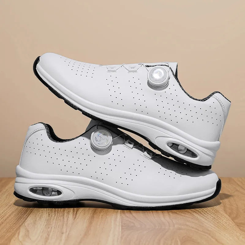 Black and white low-top mesh casual tennis shoes with cross shoulder straps and a flat sole.