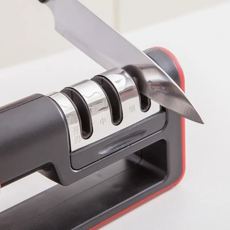 Black and red professional three-stage diamond knife sharpener on a kitchen countertop