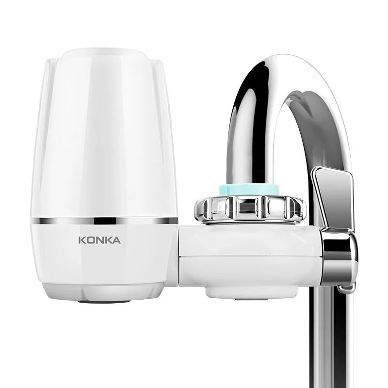 White plastic faucet water filter unit with adapters and ceramic cartridge for kitchen tap installation.
