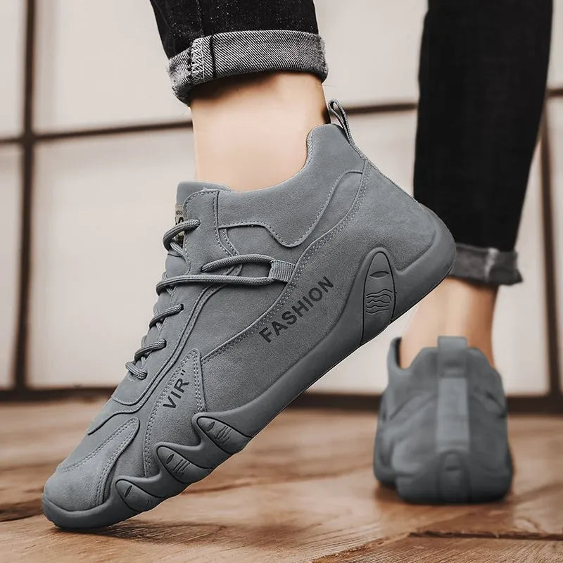 Men's grey low-cut casual work shoes with elastic band and non-slip sole on a plain background.