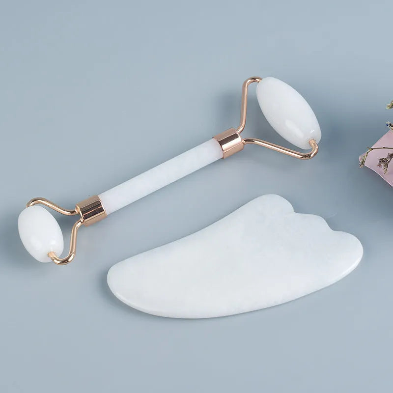 White jade double-headed roller and scraping board set for facial and body massage.
