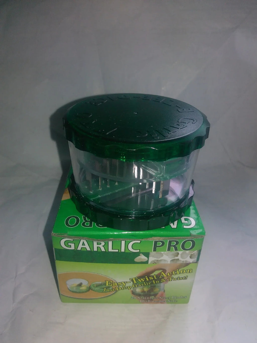 Green transparent garlic peeler kitchen gadget measuring 8.5cm by 8.5cm by 6cm