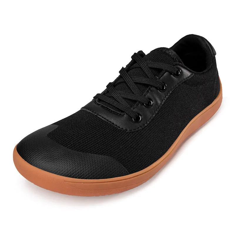 Men's low-top training shoe in a solid colour with a mesh upper and ribbed outsole, shown in a larger size.