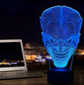A modern 3D LED table lamp with a colourful gradient display, sitting on a square base with a USB cable.
