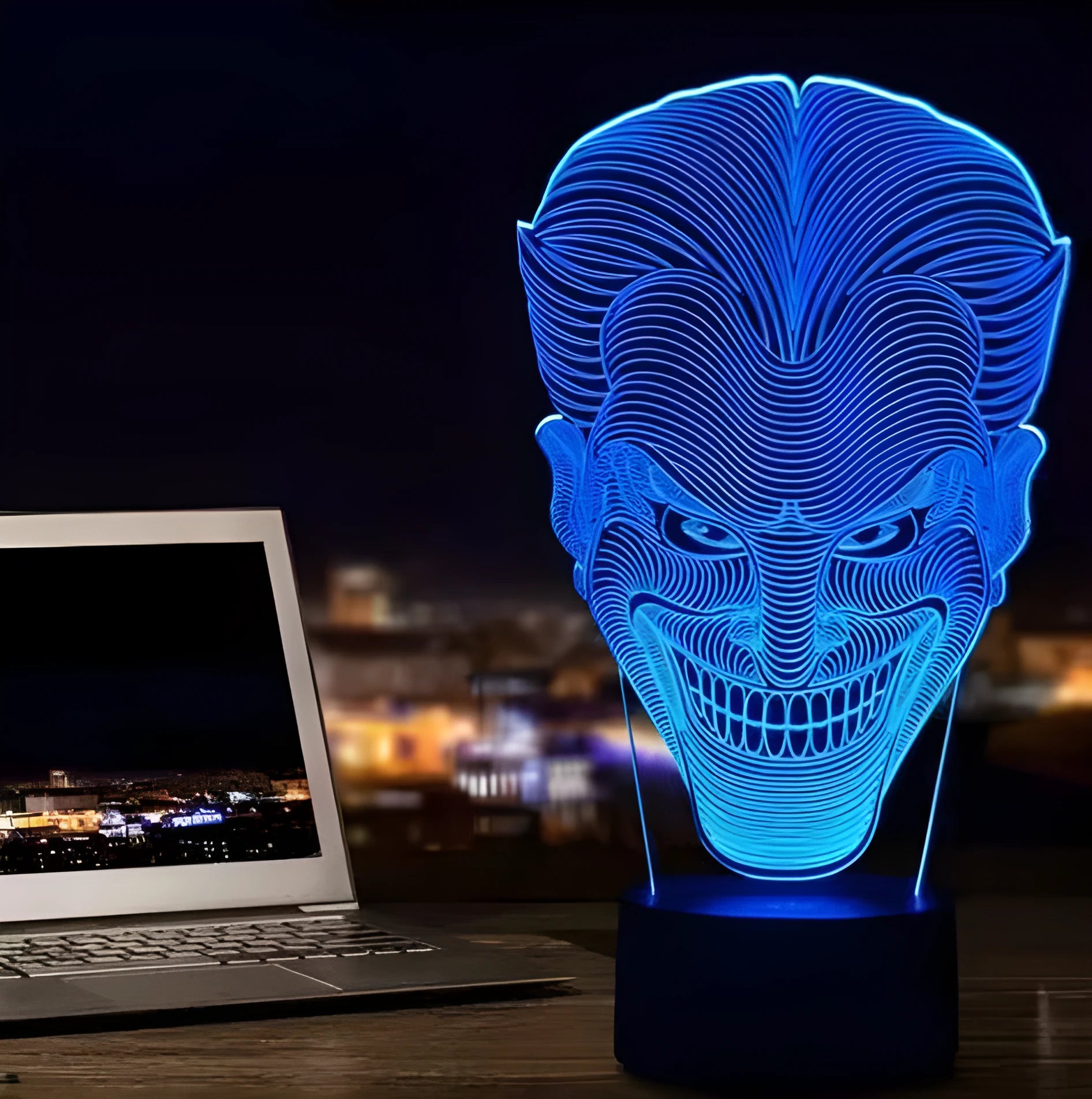 A modern 3D LED table lamp with a colourful gradient display, sitting on a square base with a USB cable.