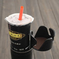 Car multifunction cup holder and navigation bracket in various colours on dashboard