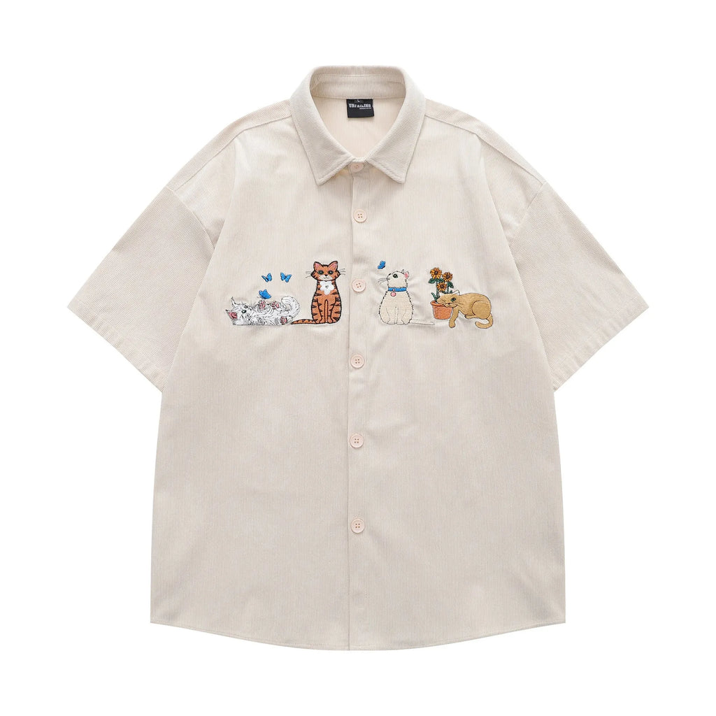 Loose cardigan shirt with embroidered cartoon pattern in apricot, brown, and black colours