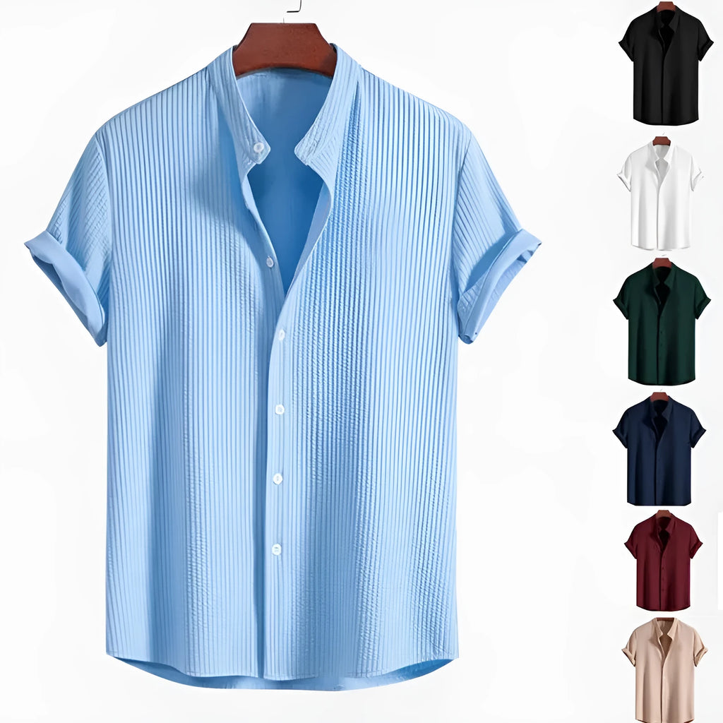 A man's loose-fitting short sleeve casual shirt in a solid colour, made from lightweight polyester fabric.