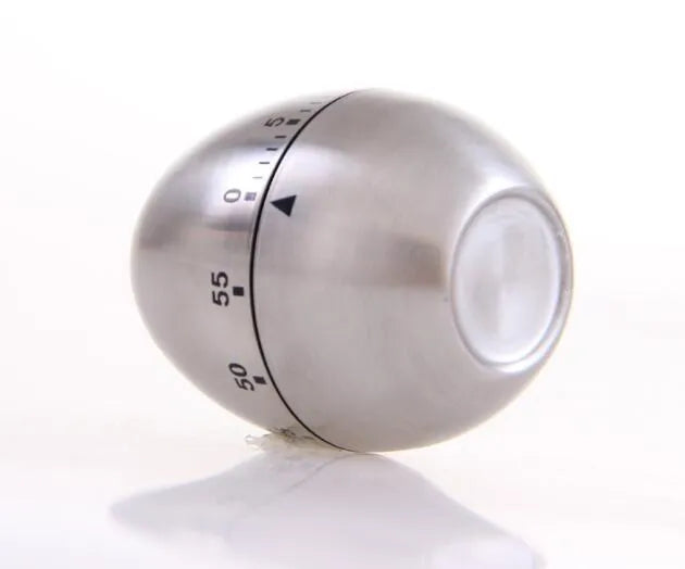 Stainless steel egg-shaped mechanical kitchen timer on a kitchen countertop