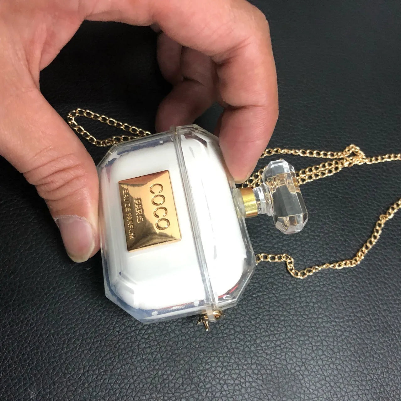 White silicone perfume bottle style case for AirPods Pro and AirPods 3 charging box.