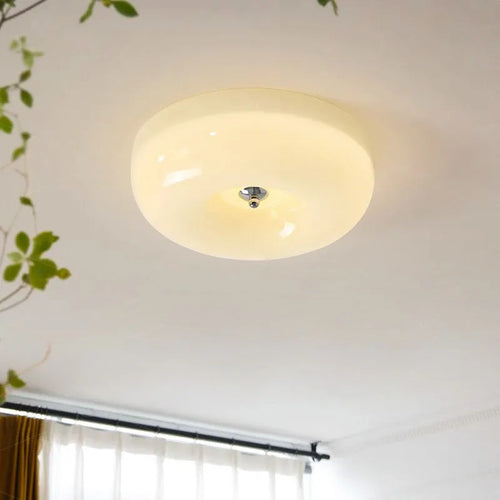 American style cream coloured bedroom ceiling lamp with three-colour light fitting on a white ceiling.